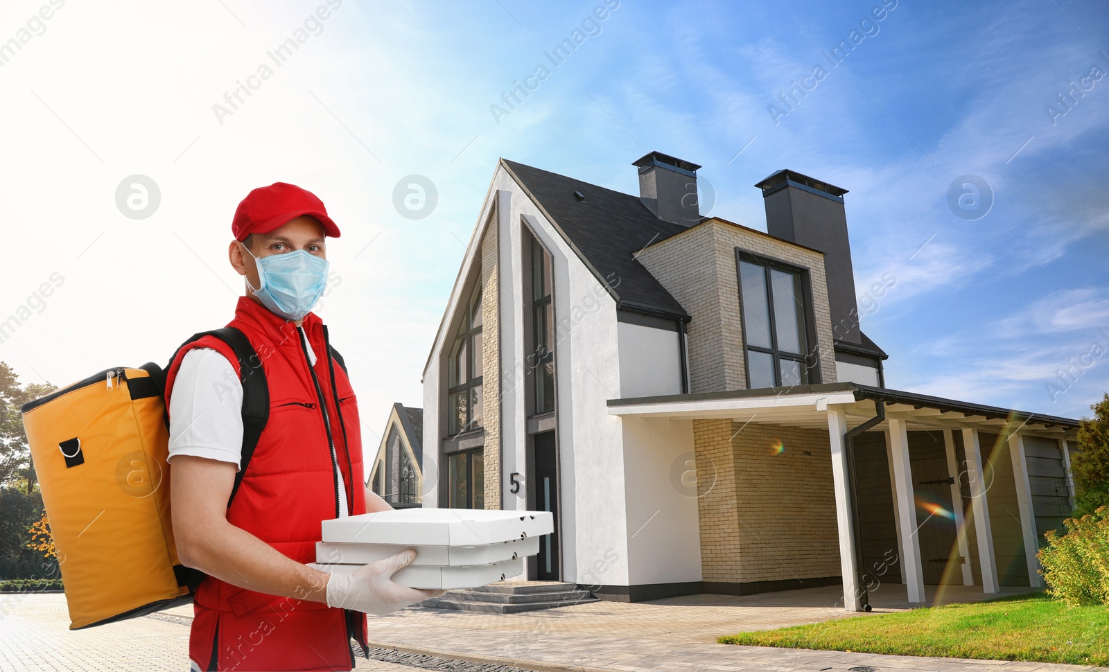 Image of Courier in protective mask and gloves with order on street. Delivery service during coronavirus quarantine