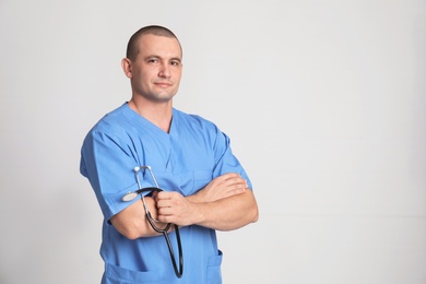 Photo of Portrait of medical assistant with stethoscope on color background. Space for text