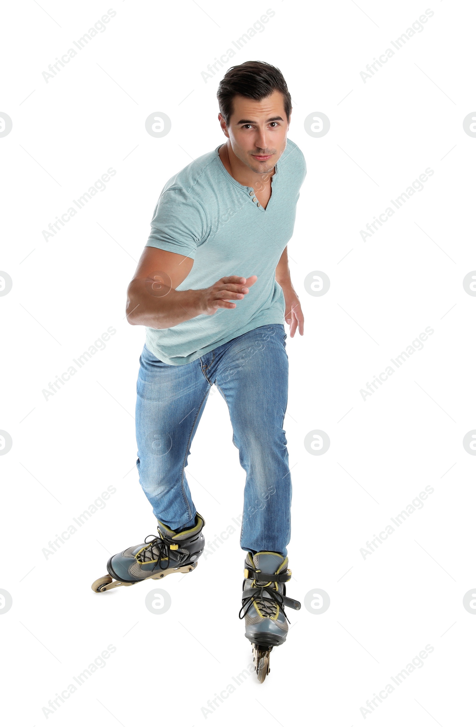 Photo of Handsome young man with inline roller skates on white background