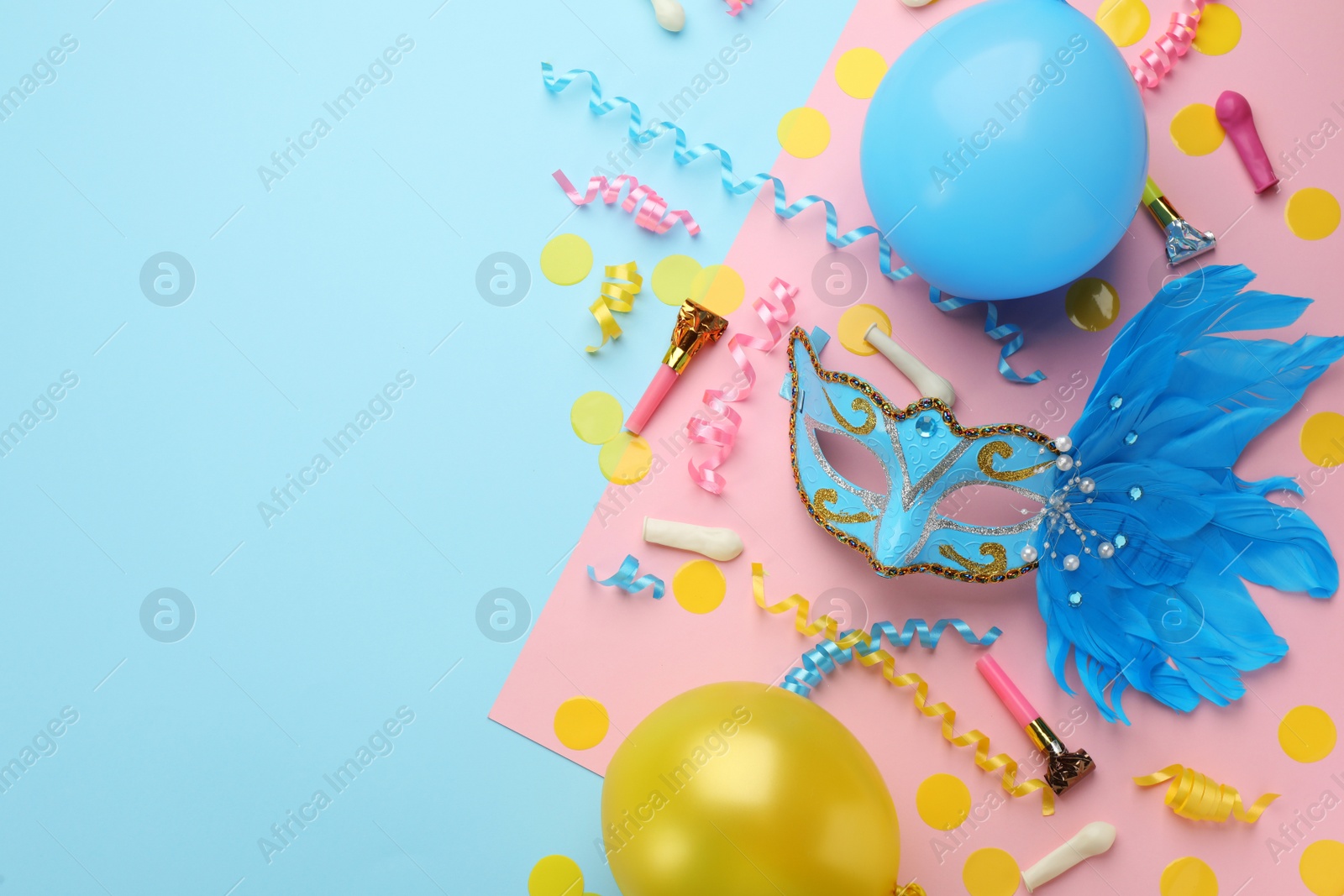 Photo of Flat lay composition with carnival items on color background. Space for text