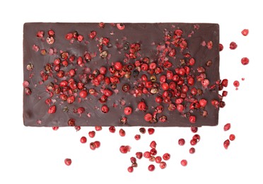 Photo of Dark chocolate bar with red peppercorns isolated on white, top view