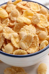 Photo of Bowl of tasty corn flakes on table, closeup