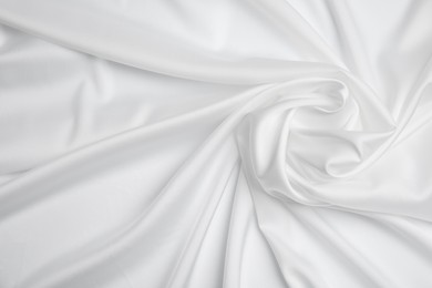 Photo of Texture of delicate white fabric as background, top view