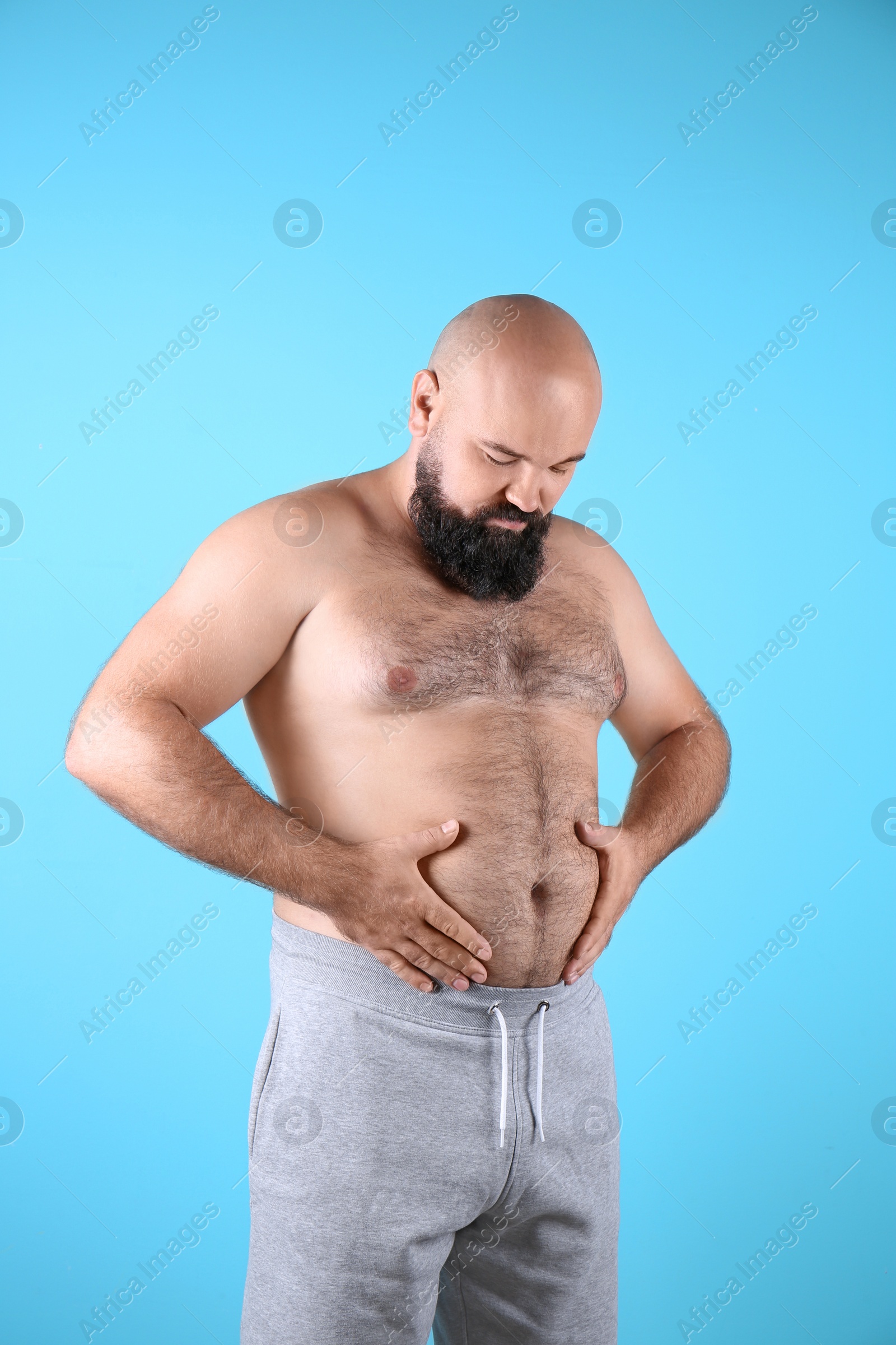Photo of Fat man on color background. Weight loss