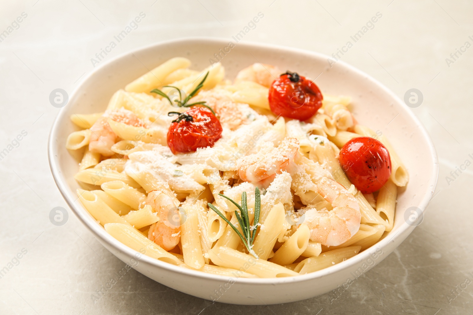 Photo of Delicious pasta with shrimps on light grey table