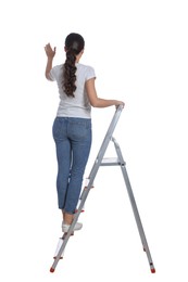 Photo of Young woman on metal ladder against white background, back view