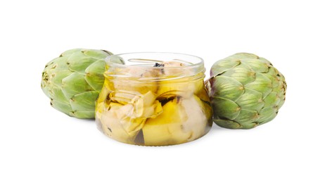Photo of Open jar of delicious artichokes pickled in olive oil and fresh vegetables on white background
