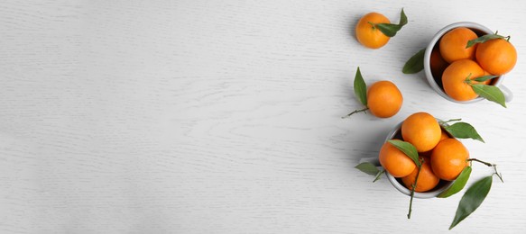 Image of Flat lay composition with fresh ripe tangerines on white wooden table, space for text. Banner design