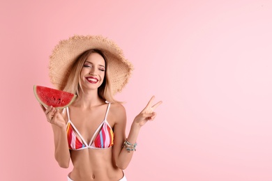 Photo of Pretty young woman with juicy watermelon on color background