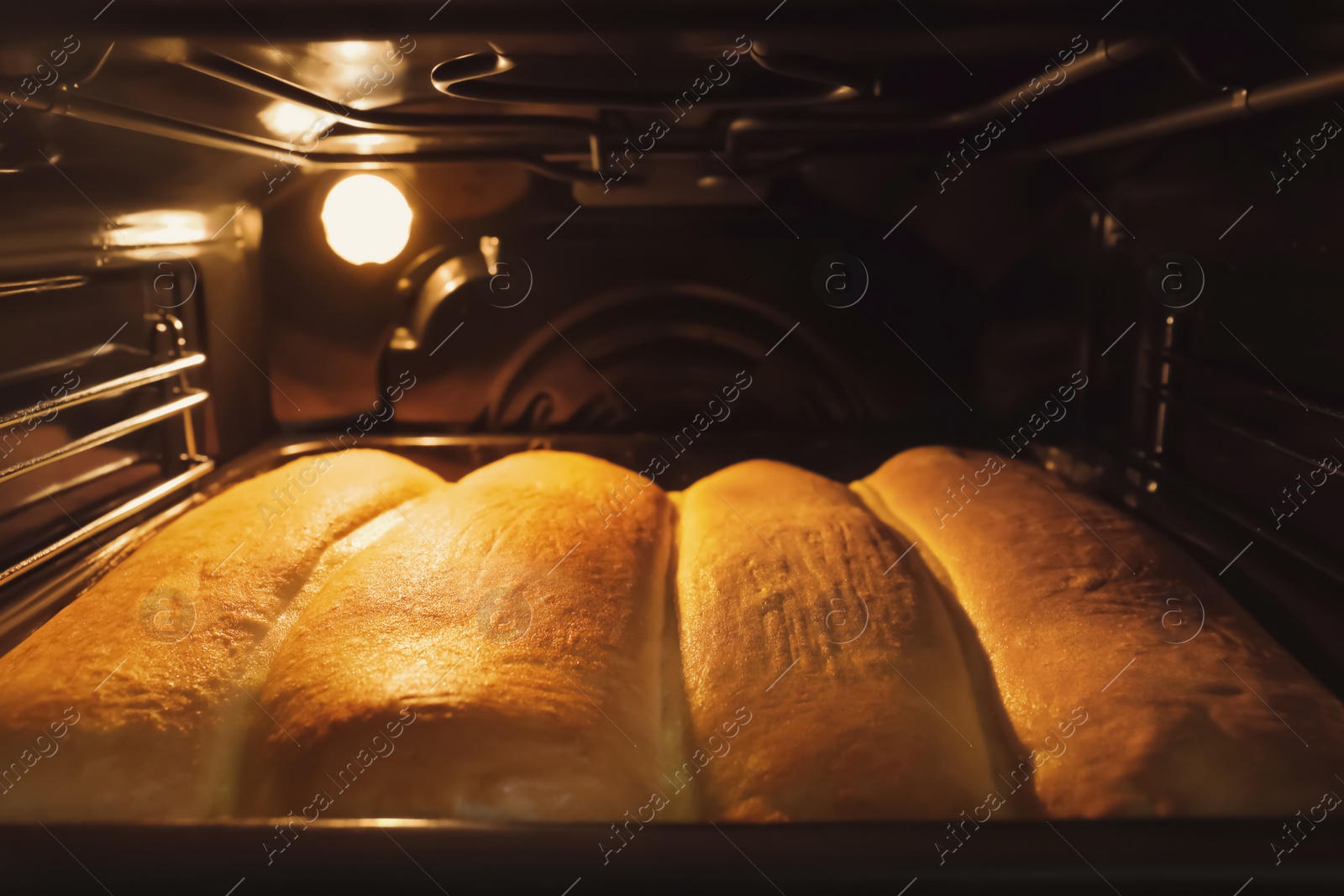 Photo of Baking tasty pastry in oven, closeup view