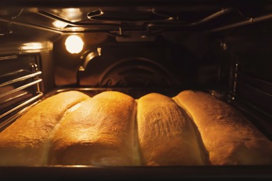 Photo of Baking tasty pastry in oven, closeup view