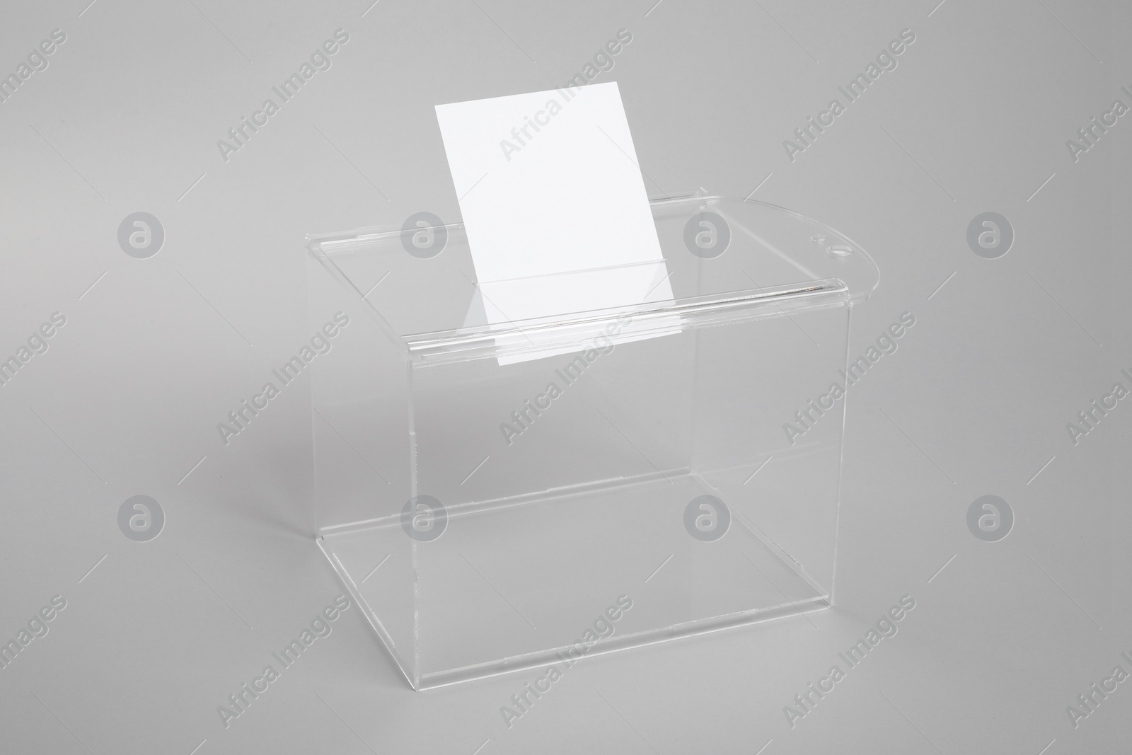 Photo of Ballot box with vote on light grey background. Election time