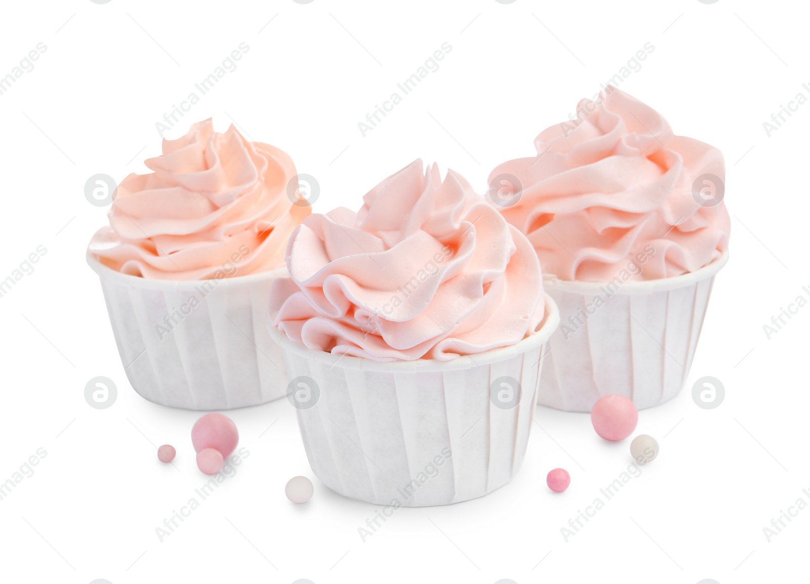 Photo of Tasty cupcakes with cream and sprinkles isolated on white