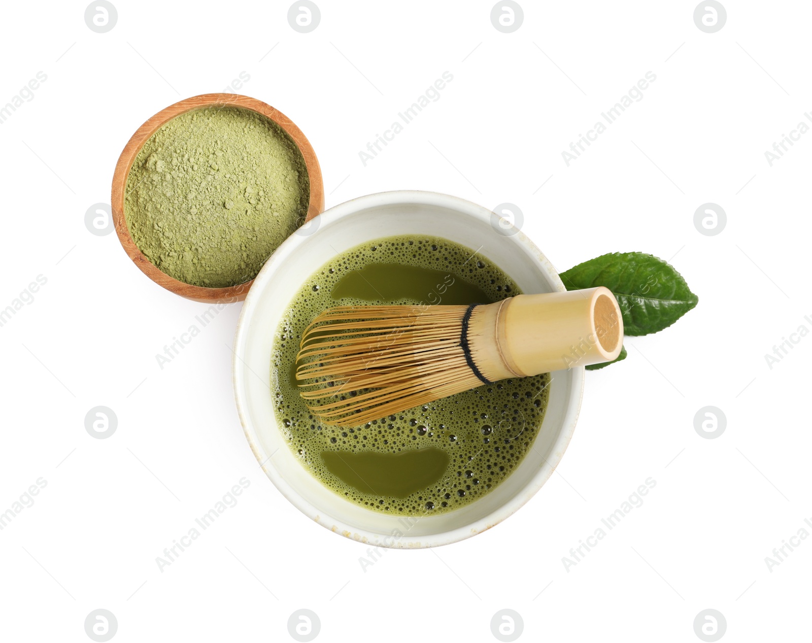 Photo of Cup of fresh matcha tea with bamboo whisk and green powder isolated on white, top view