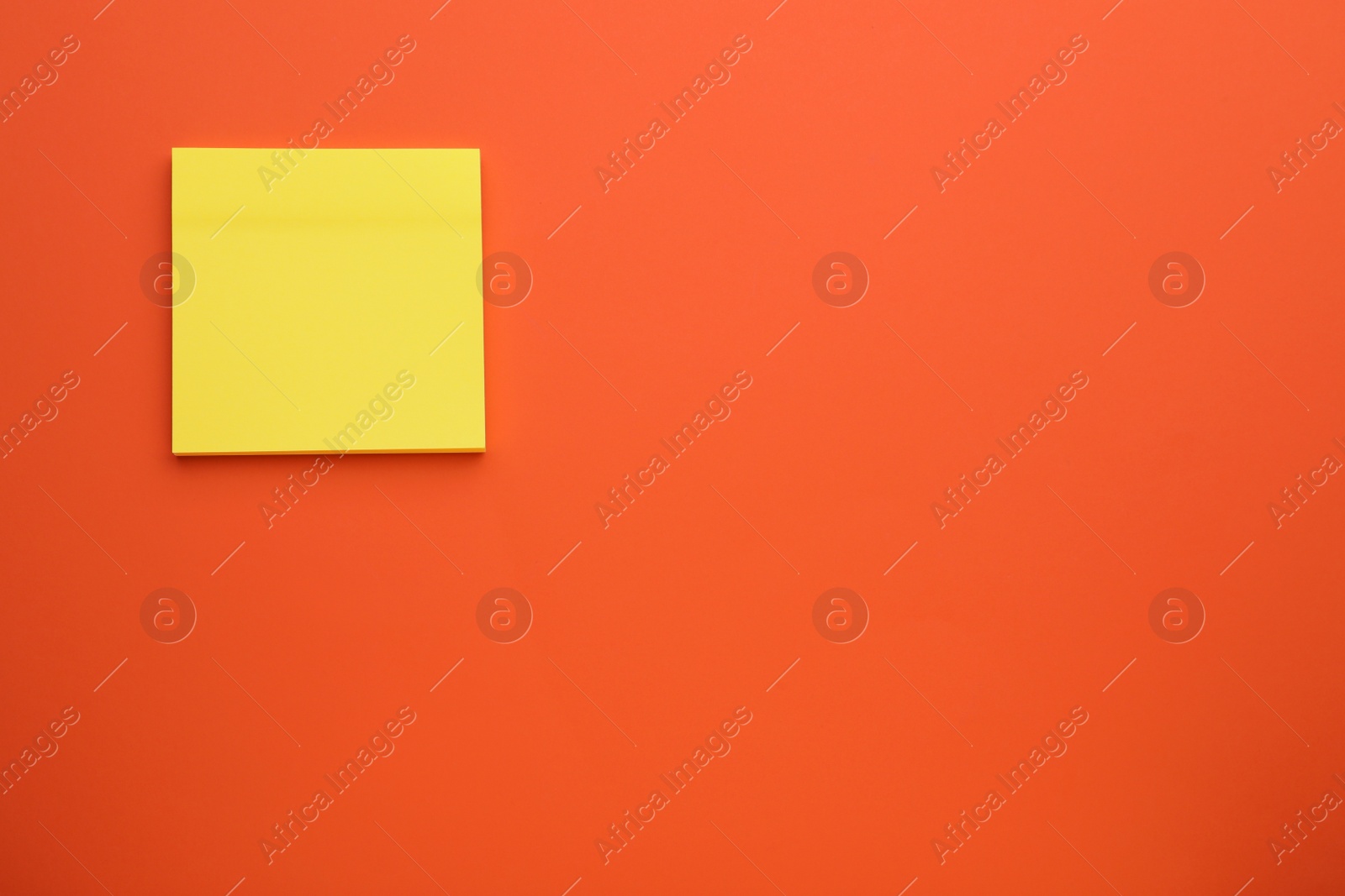 Photo of Paper note on orange background, top view. Space for text