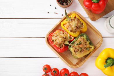 Photo of Flat lay composition with tasty stuffed bell peppers on white wooden table, top view