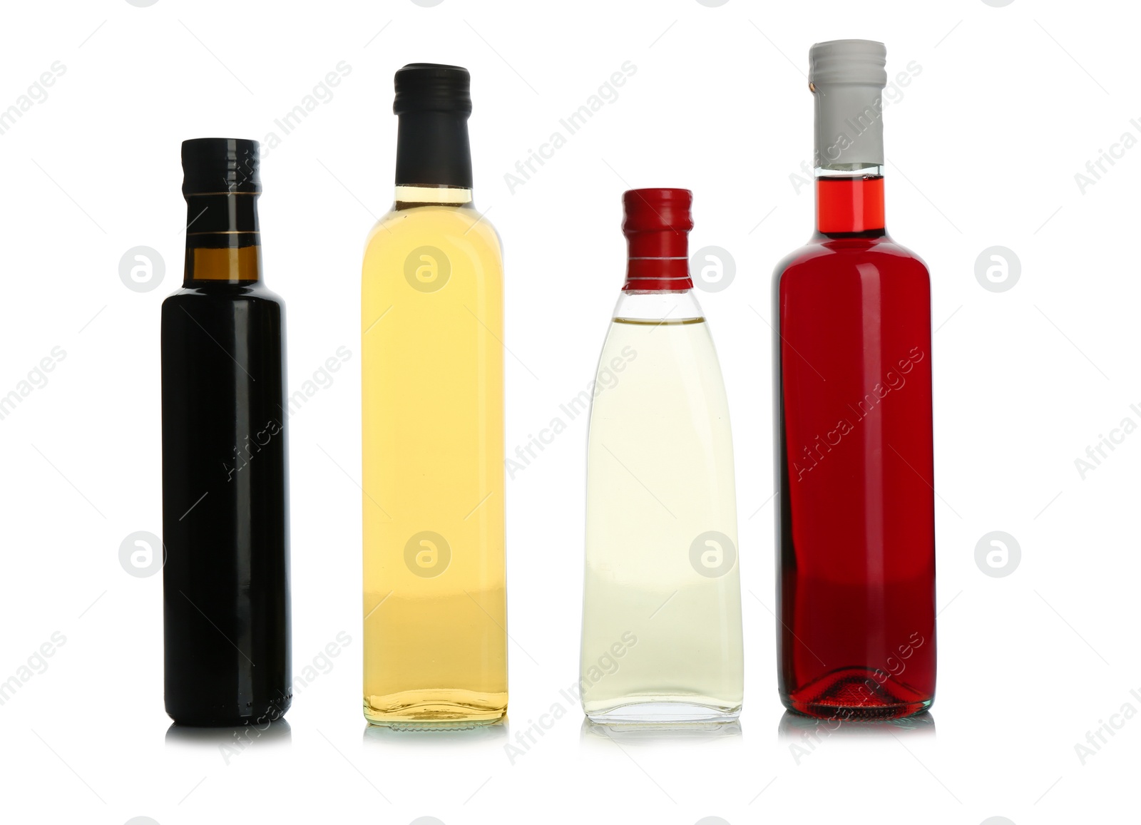 Photo of Glass bottles with different kinds of vinegar on white background