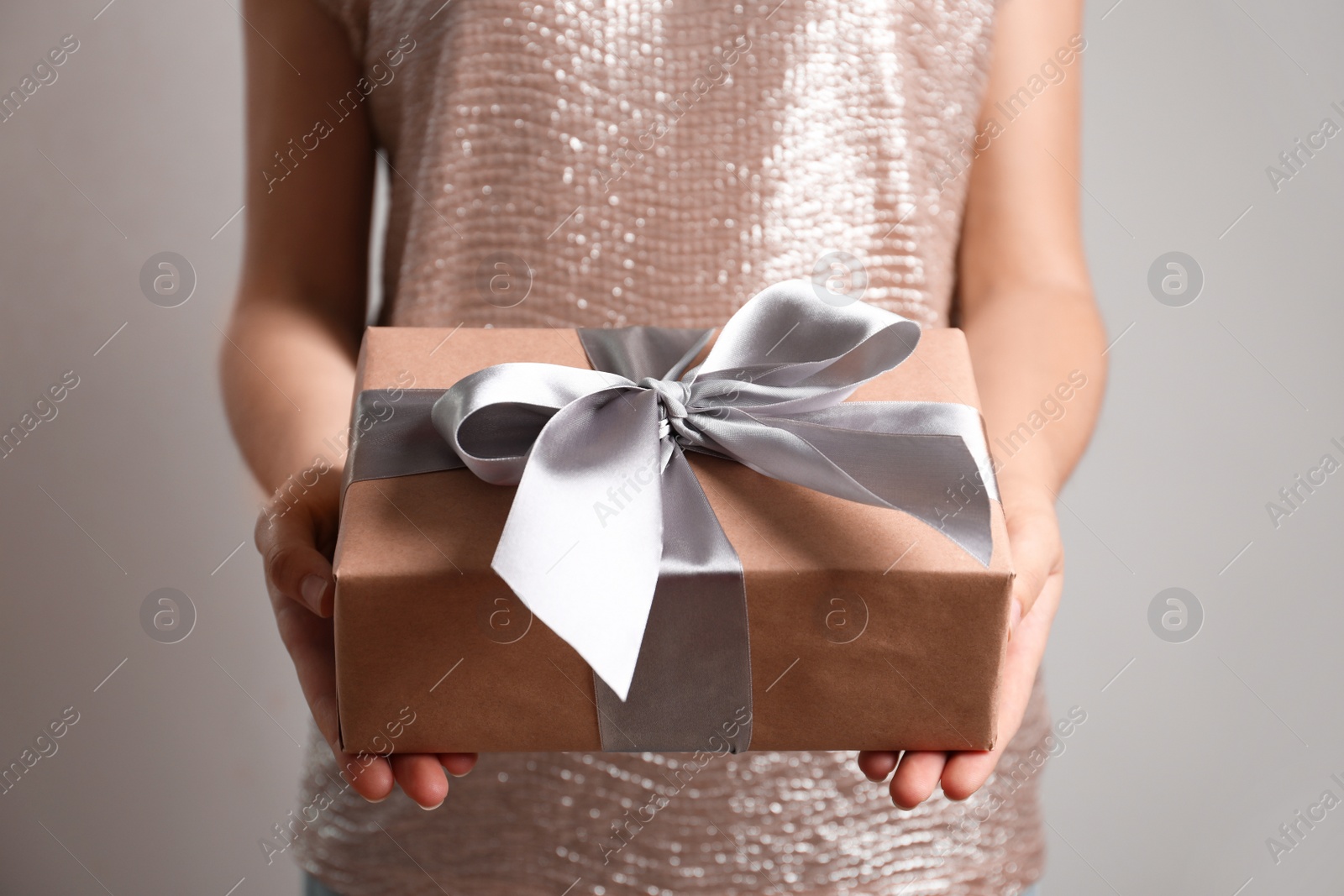 Photo of Woman holding beautiful gift box, closeup