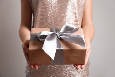 Woman holding beautiful gift box, closeup