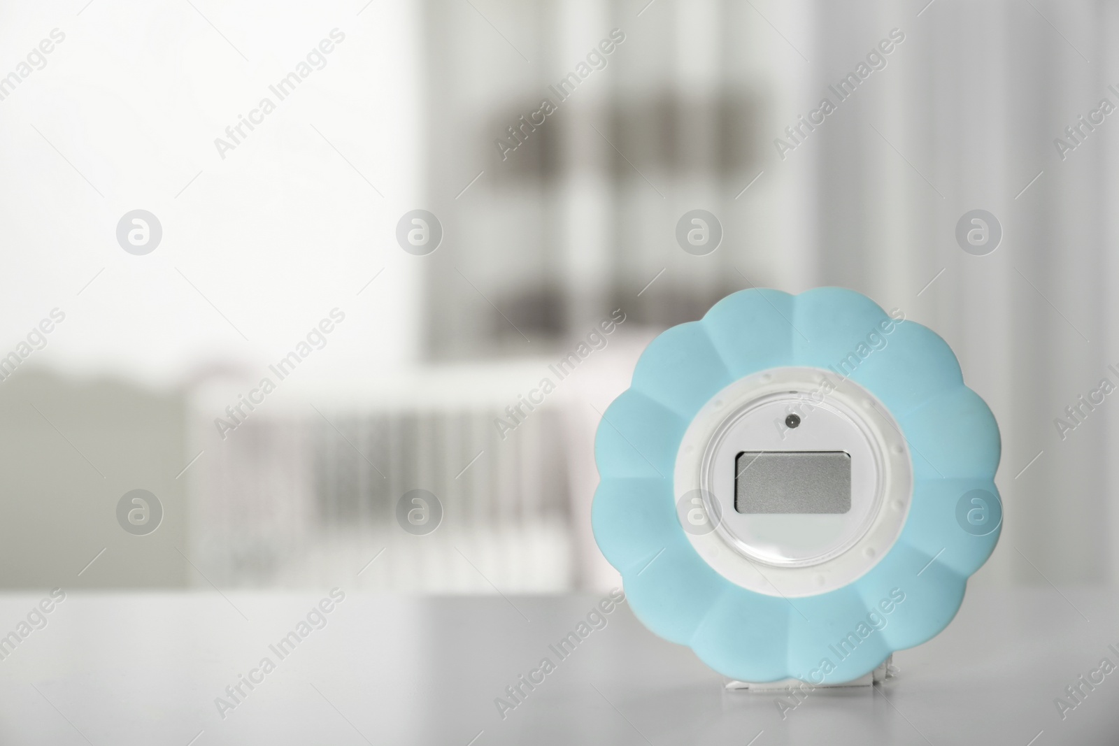 Photo of Digital temperature and humidity control in baby room interior. Space for text