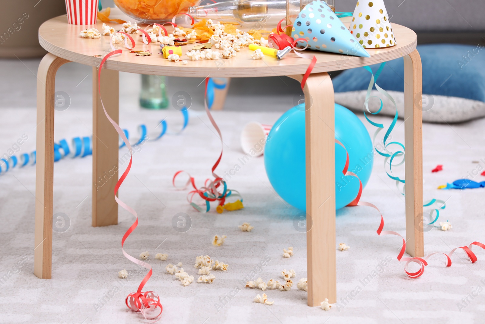 Photo of Wooden table with mess after party indoors