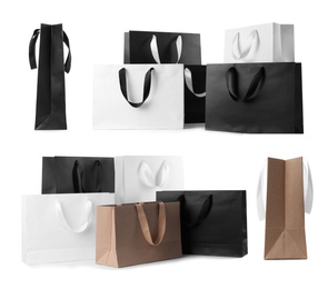 Set with different paper shopping bags on white background