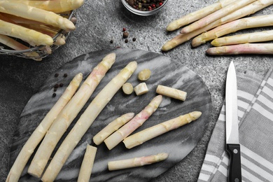 Flat lay composition with white asparagus on grey table