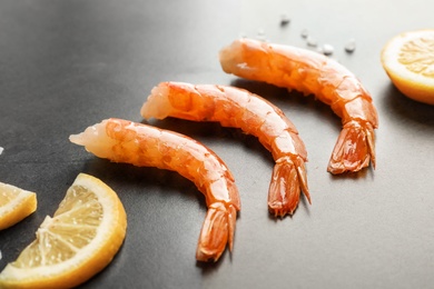 Delicious shrimps with lemon on gray background