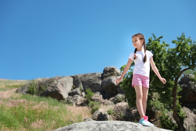 Little girl outdoors on sunny day. Summer camp