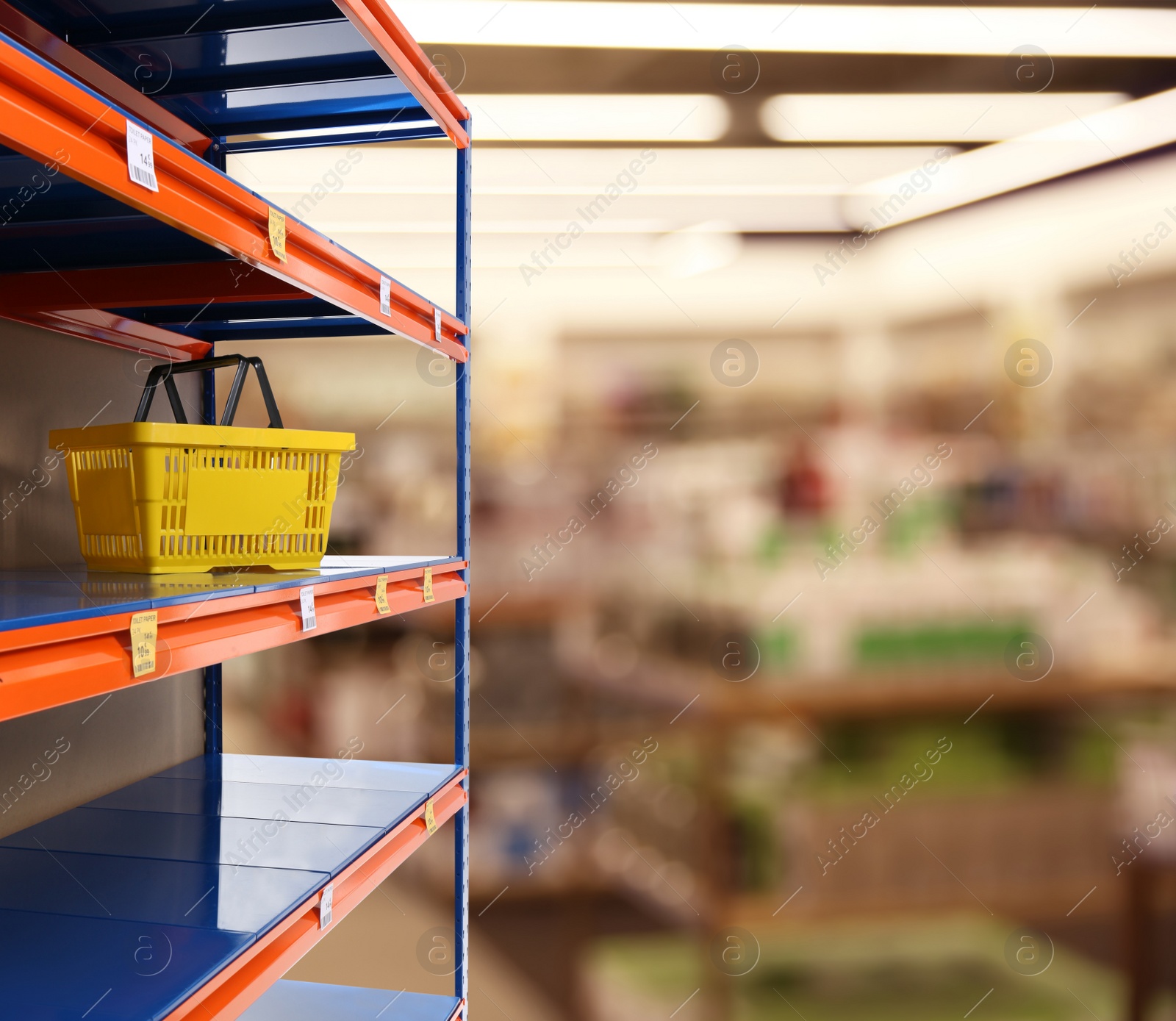 Image of Empty shelves in supermarket, closeup. Product deficiency due to social panic 