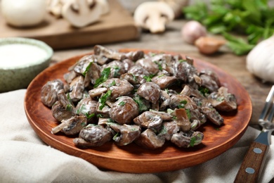 Plate of tasty fried mushrooms with sauce on table