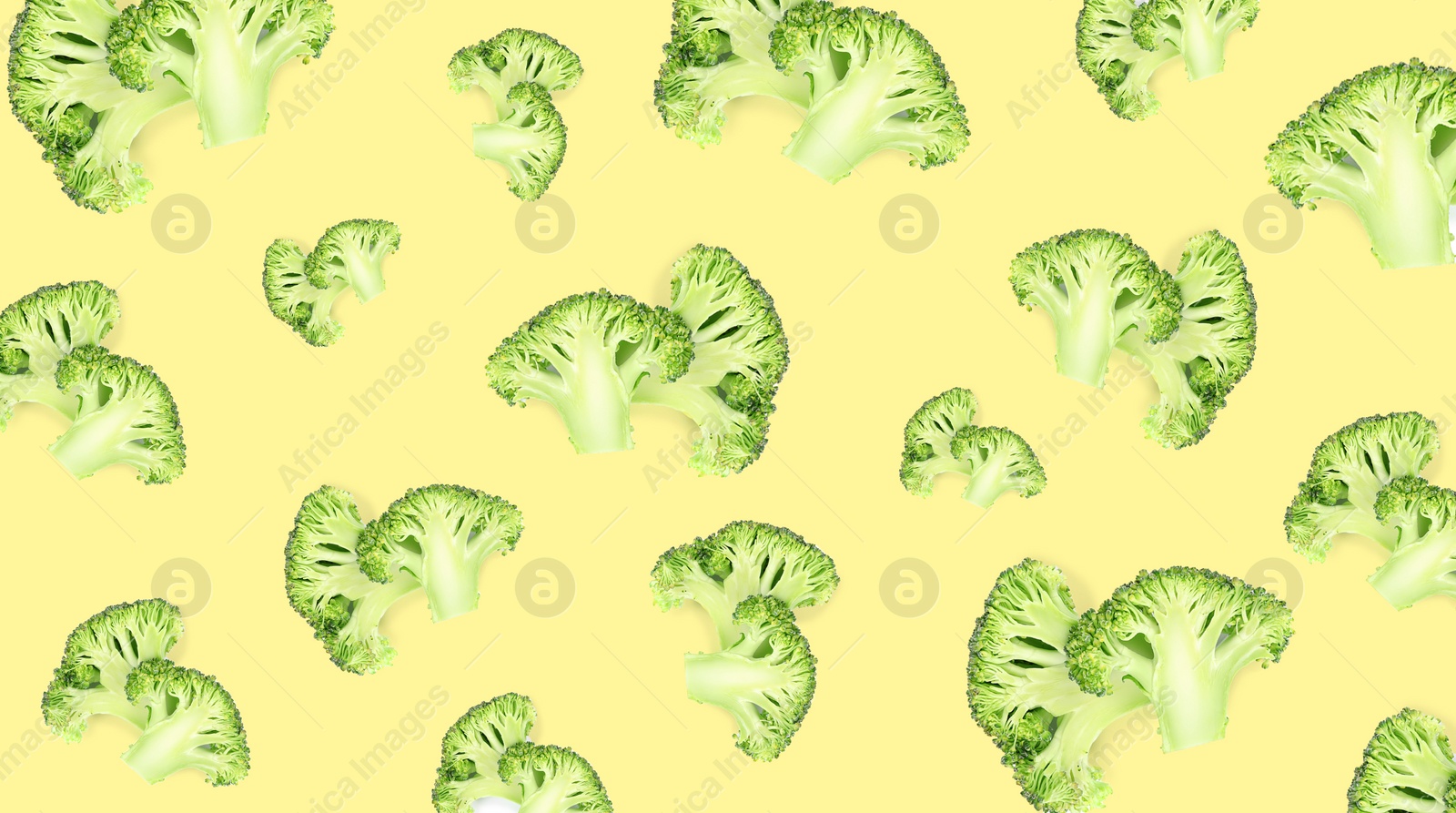 Image of Pattern of fresh green broccoli on pale light yellow background, banner design