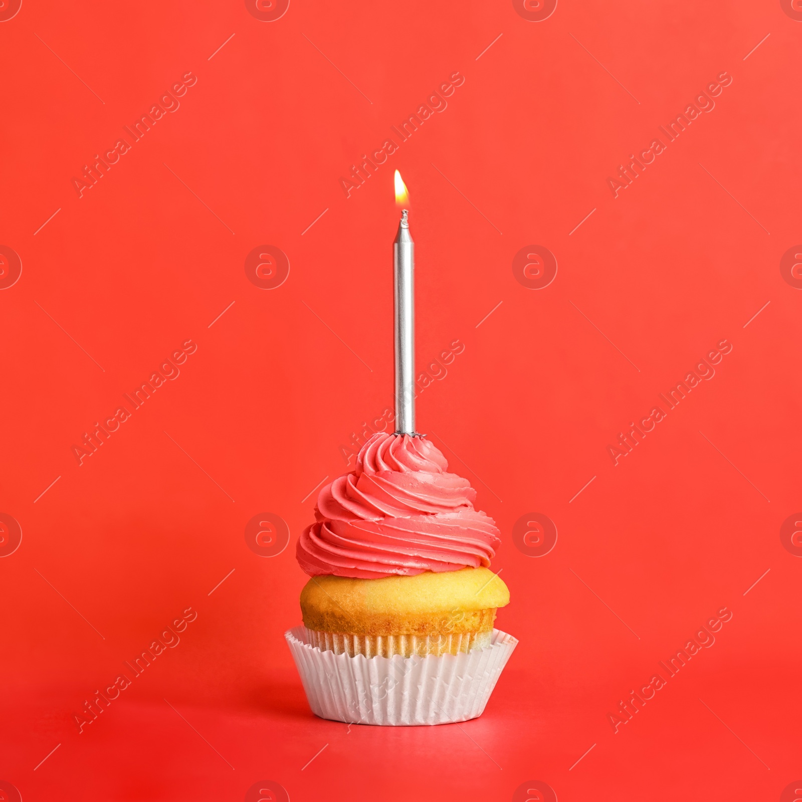 Photo of Birthday cupcake with candle on red background