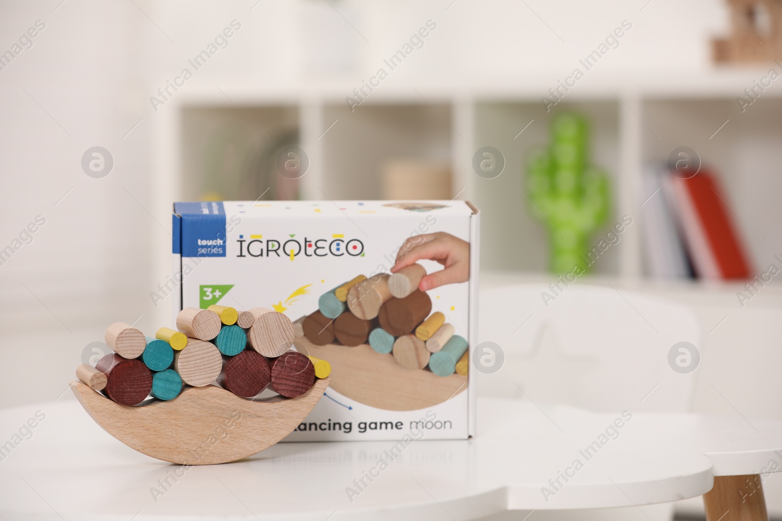 Photo of Wooden pieces of balancing game on white table indoors, space for text. Educational toy for motor skills development