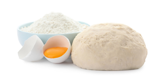 Photo of Dough, egg and flour on white background. Cooking pastries