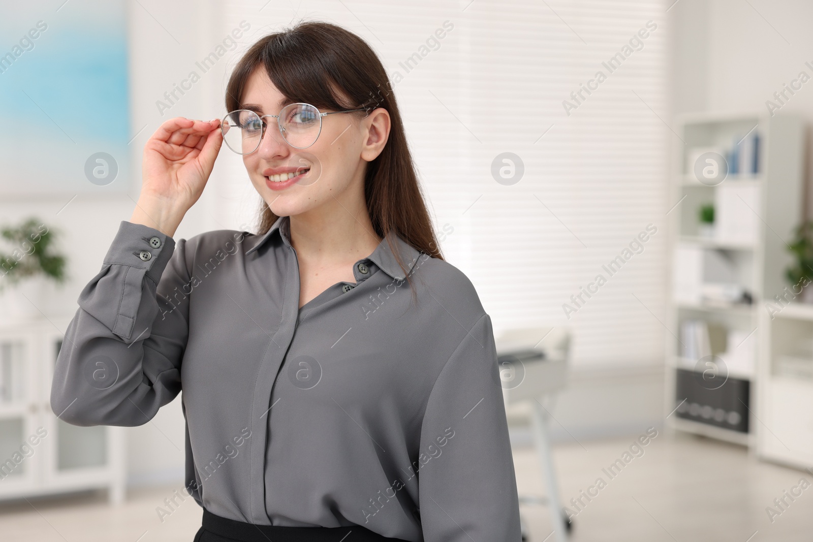 Photo of Portrait of smiling secretary in office. Space for text