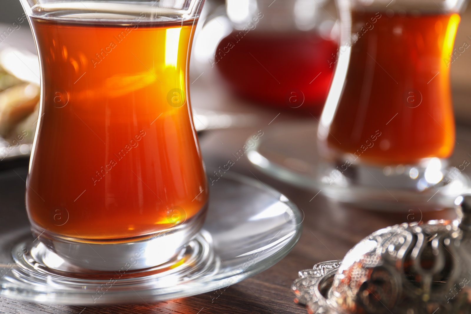 Photo of Traditional Turkish tea in glasses on table, closeup