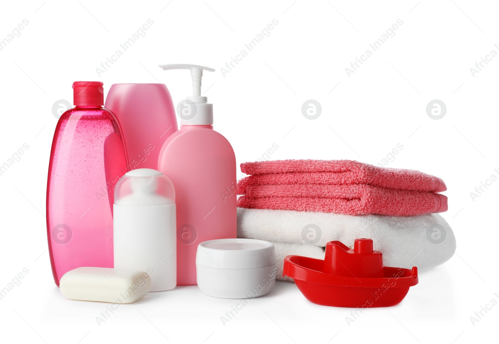 Photo of Baby cosmetic products, toy and towels on white background