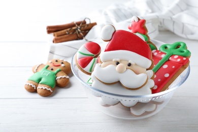Photo of Decorated Christmas cookies on white wooden table
