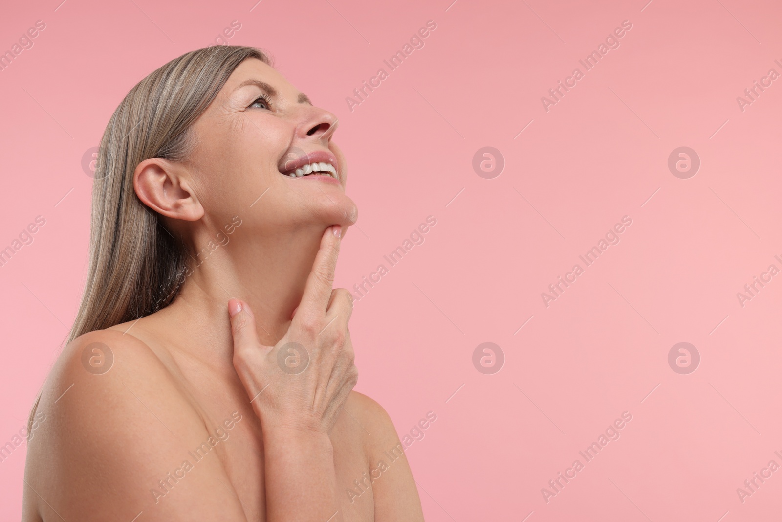 Photo of Beautiful woman with healthy skin on pink background, space for text