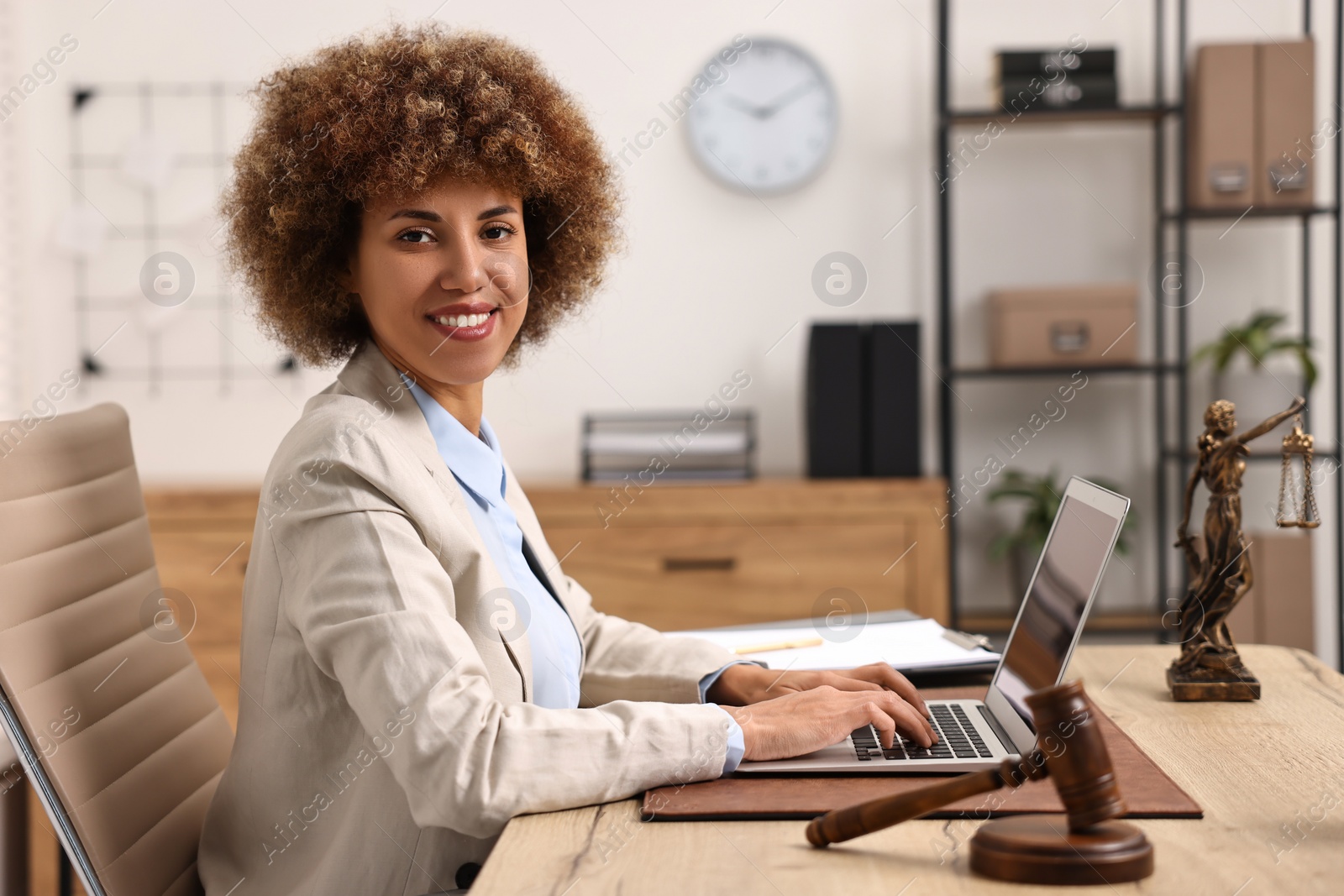 Photo of Notary with laptop at workplace in office