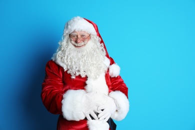 Portrait of authentic Santa Claus on color background