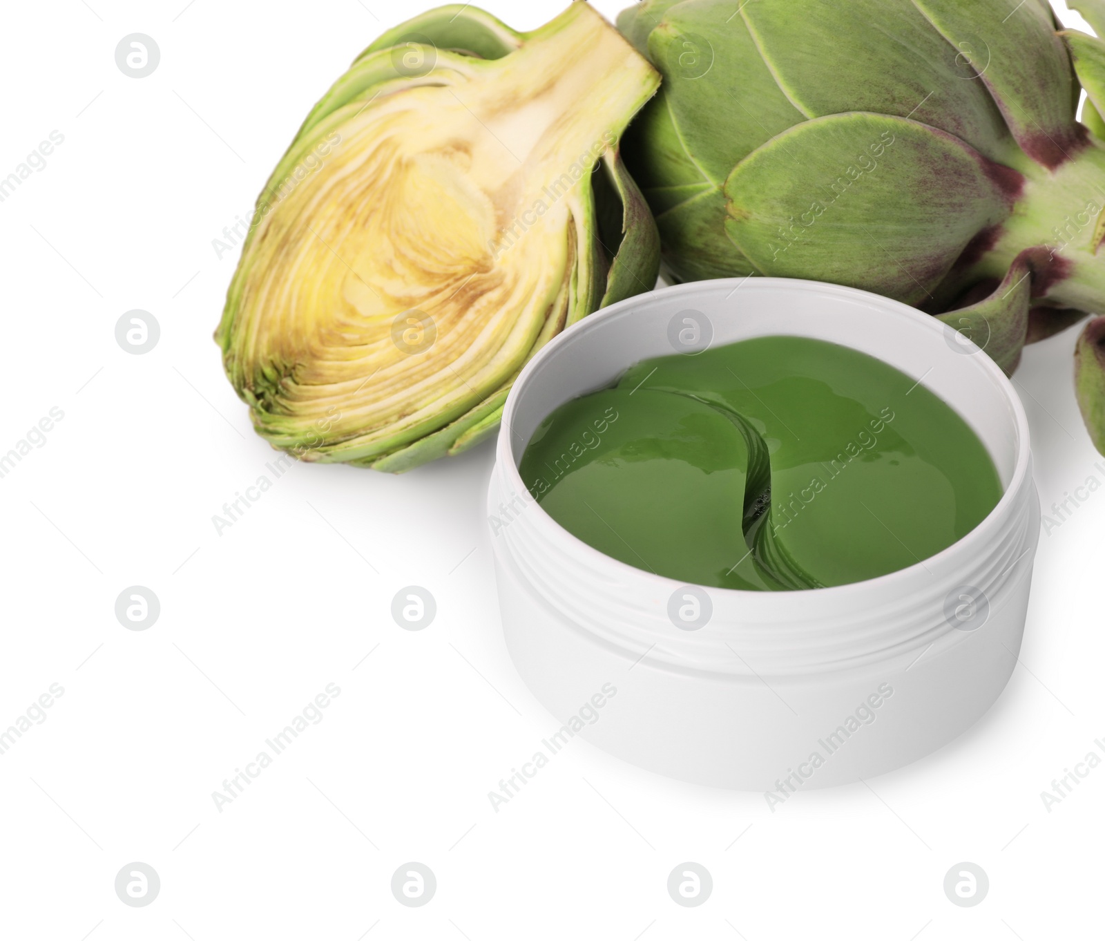 Photo of Package of under eye patches and artichokes on white background, closeup. Cosmetic product