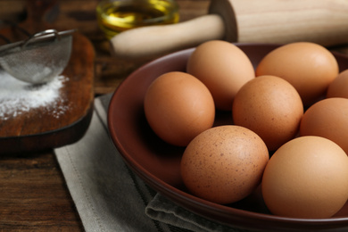 Brown chicken eggs on wooden table, closeup