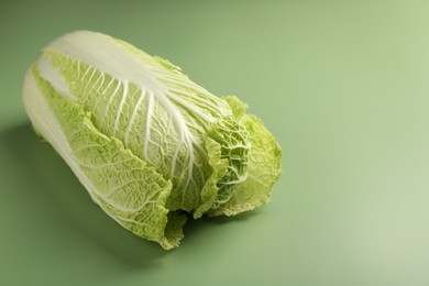 Photo of Fresh ripe Chinese cabbage on pale green background. Space for text