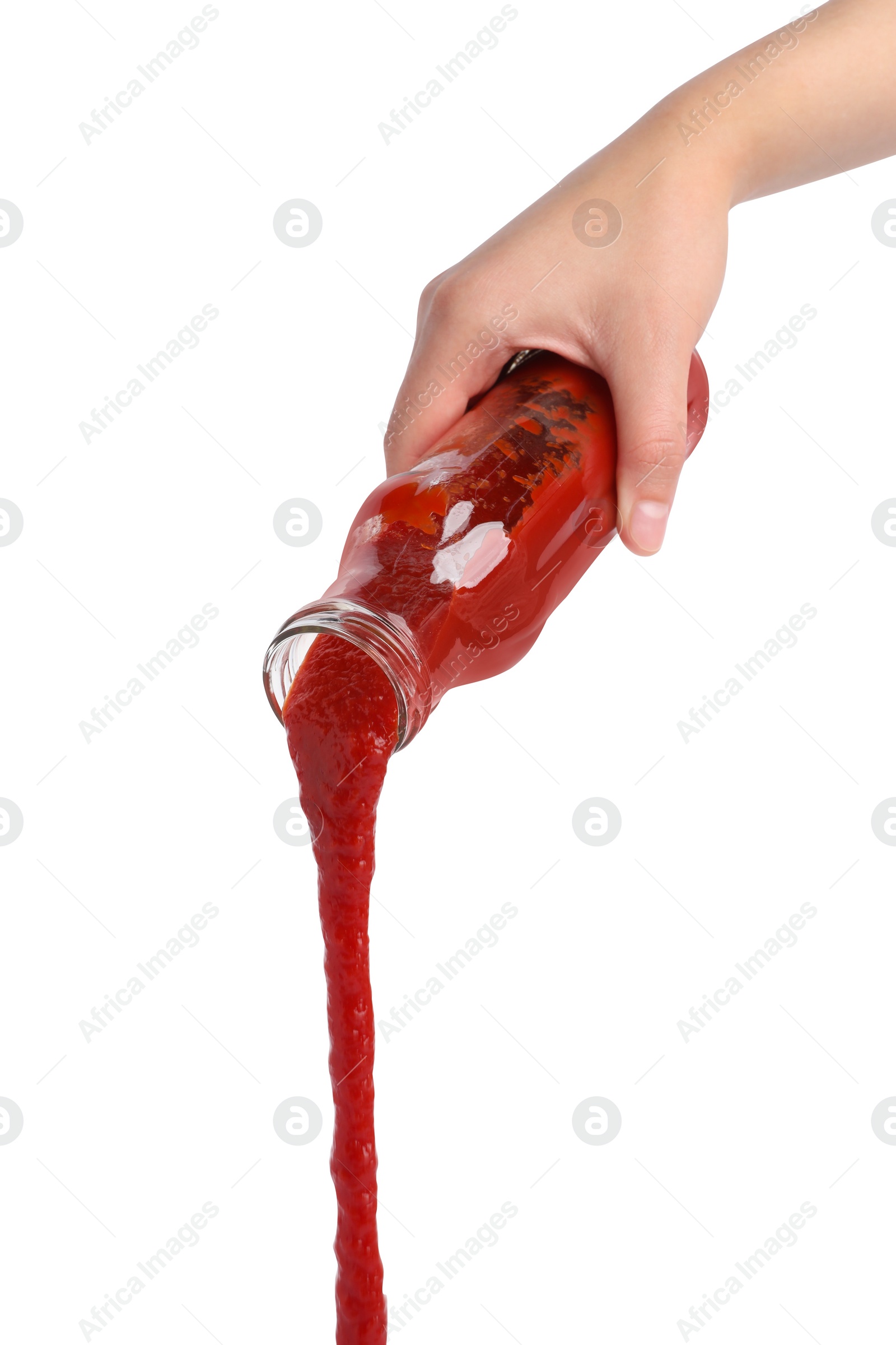 Photo of Woman pouring tasty ketchup from bottle isolated on white, closeup