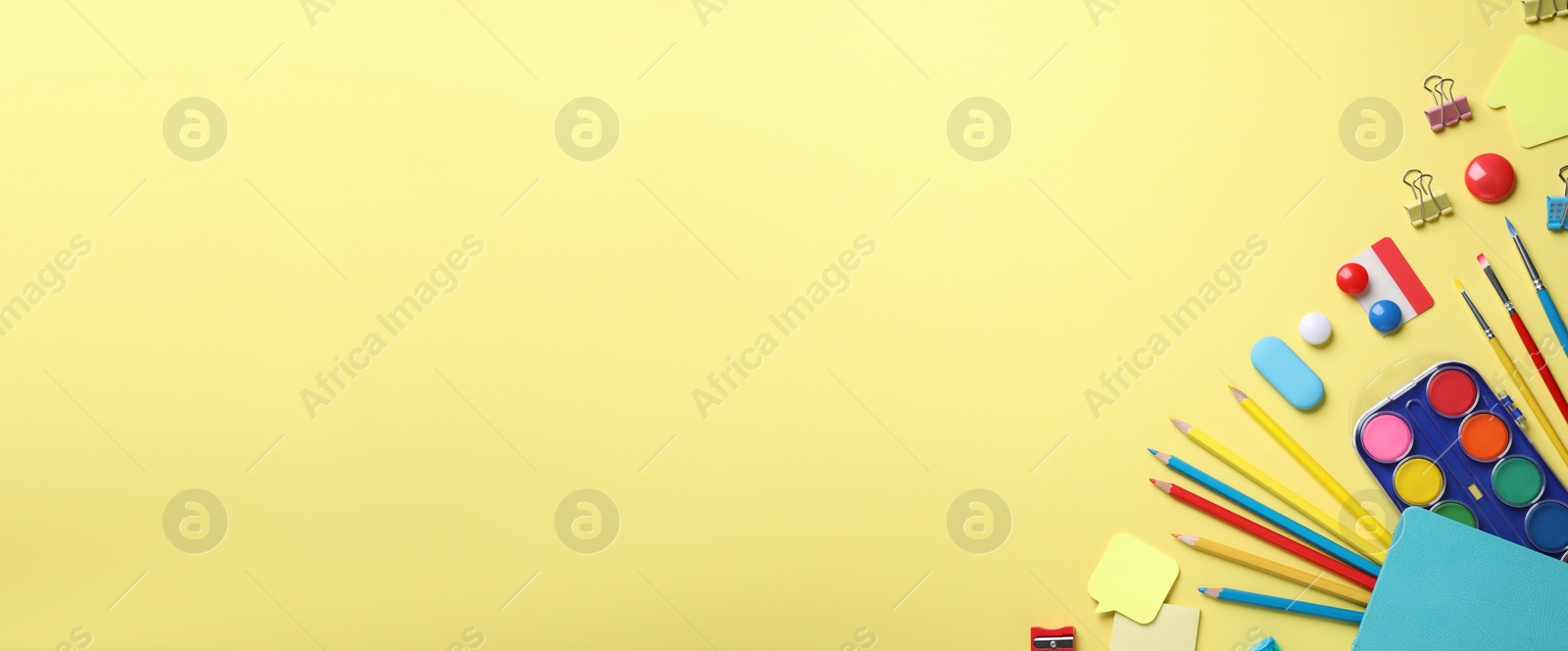 Photo of Different stationery on yellow background, flat lay. Space for text
