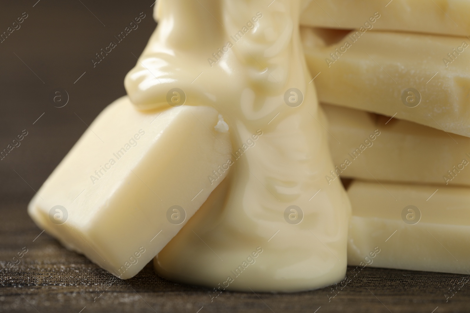 Photo of Pieces of white chocolate and tasty paste on wooden table, closeup