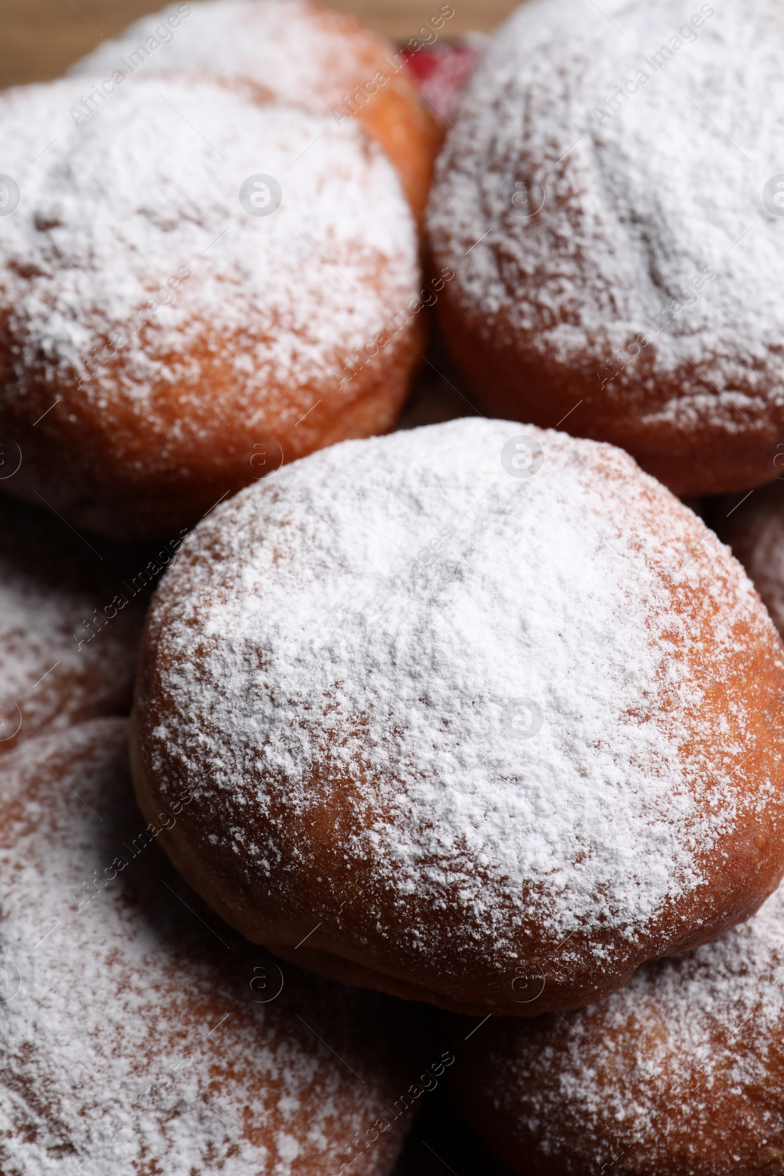 Photo of Delicious sweet buns with powdered sugar, closeup