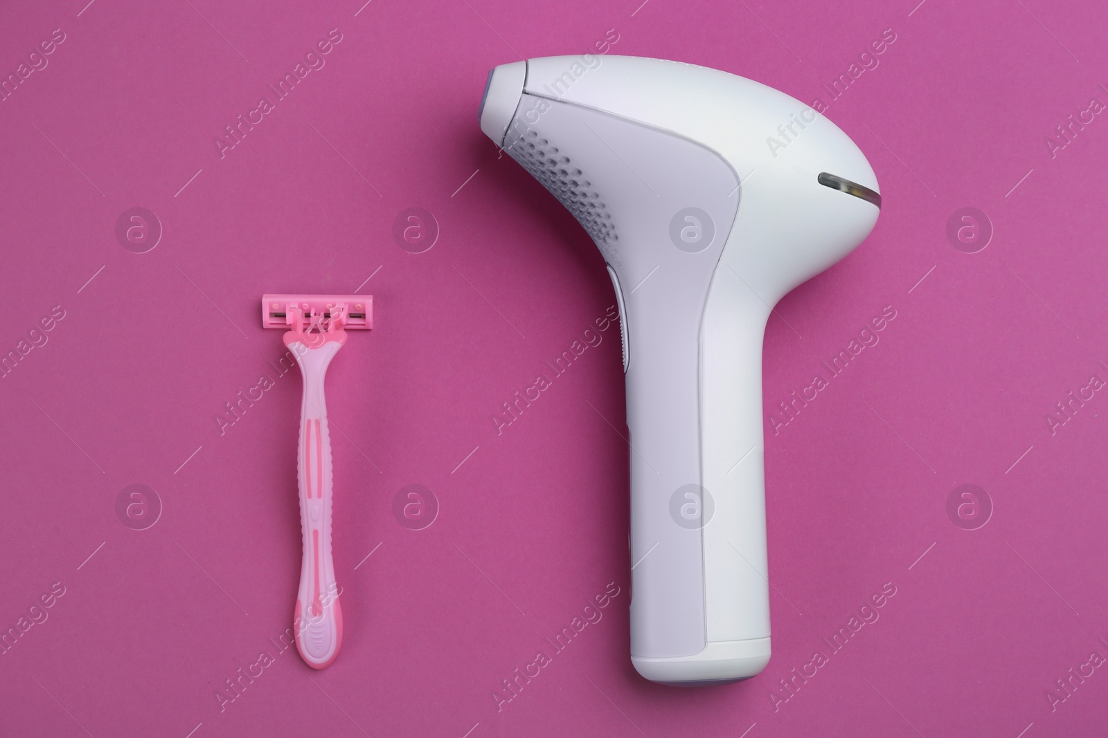 Photo of Modern photoepilator and razor on purple background, flat lay